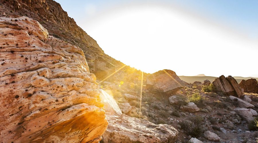 sunrise coming up over desert rocks Page Picker