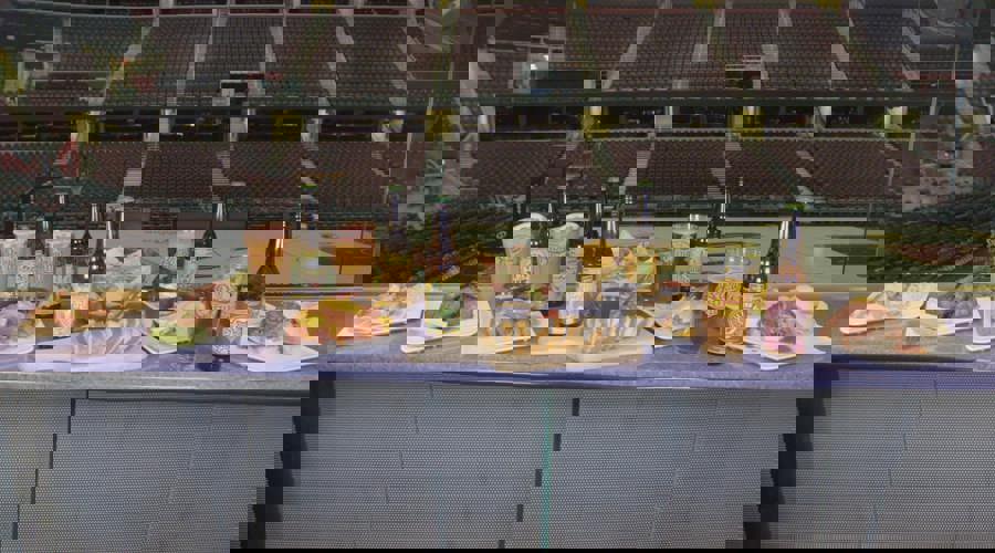 Beer bottles and food on table in basketball arena Page Picker