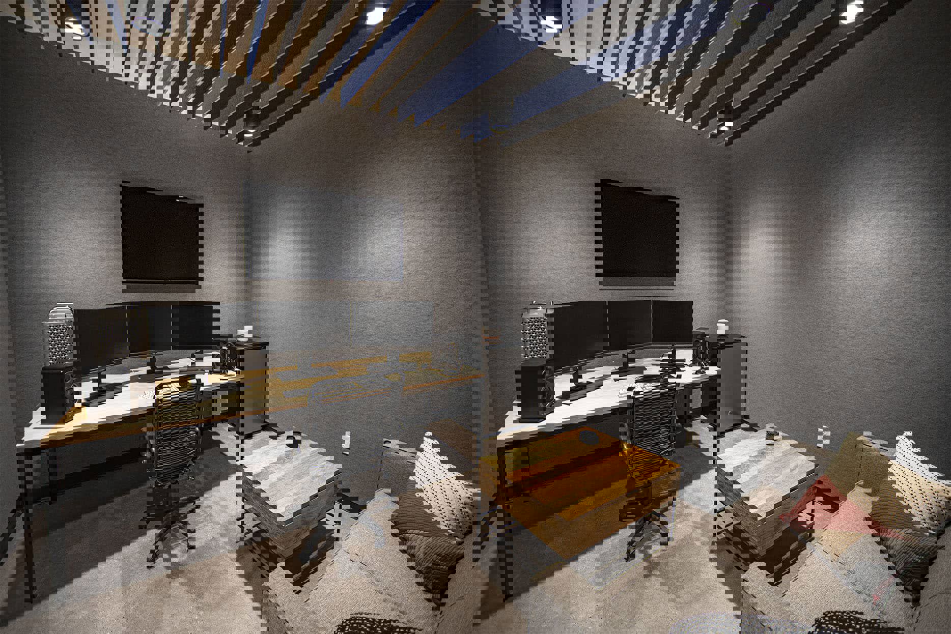 Private editing suite with multiple computer monitors and a couch
